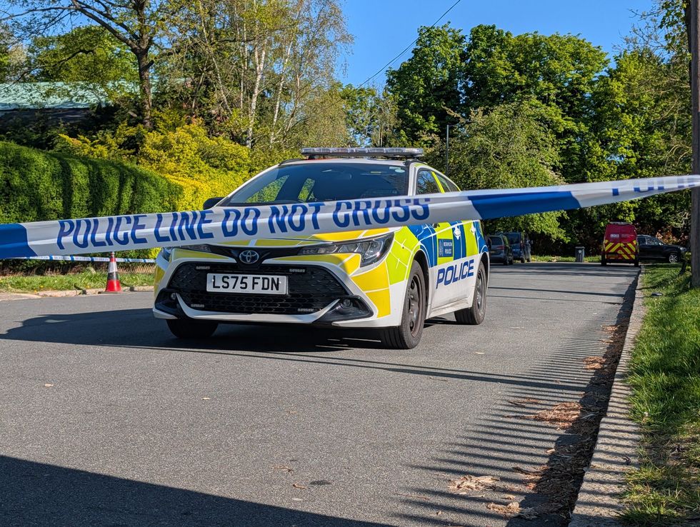 Police officers patrol at a cordon near to an incident at the Kenton United Synagogue