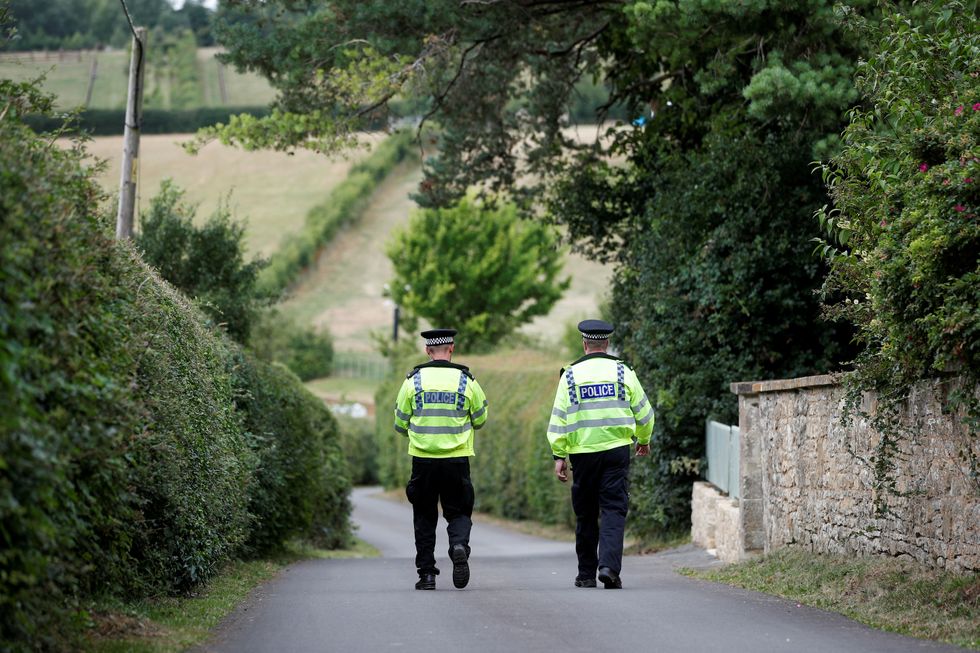 Police officers patrol near the venue of the event.