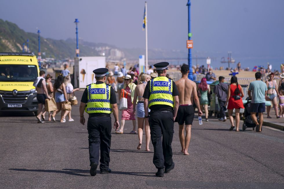 Police officers patrol the promenade as people enjoy the warm weather on Bournemouth Beach in Dorset. Picture date: Monday September 6, 2021.