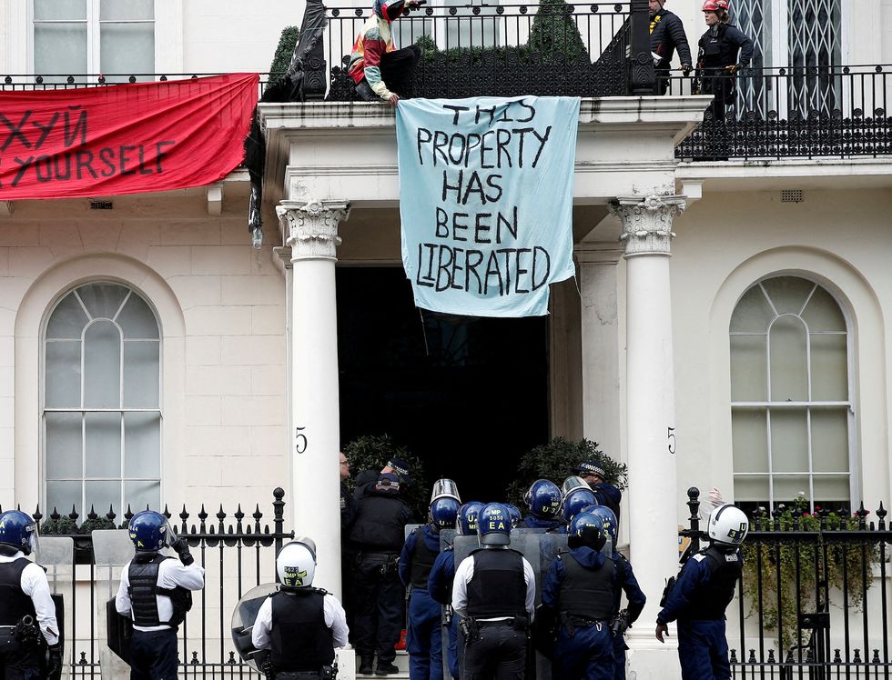 Police officers prepare to enter the occupied mansion