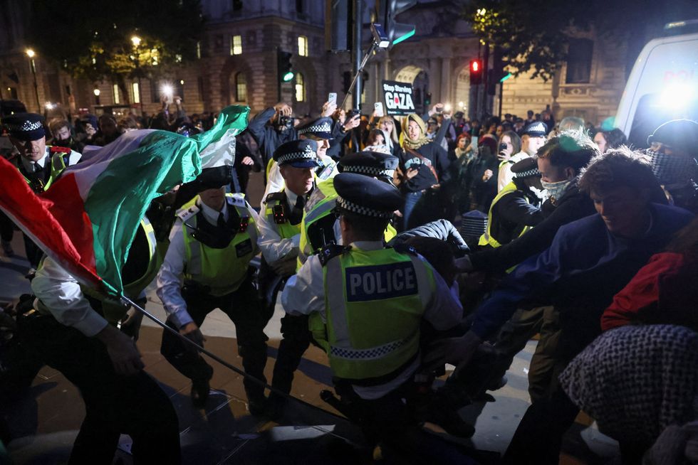 Police officers scuffle with demonstrators as they try to stop people marching in protest\u200b