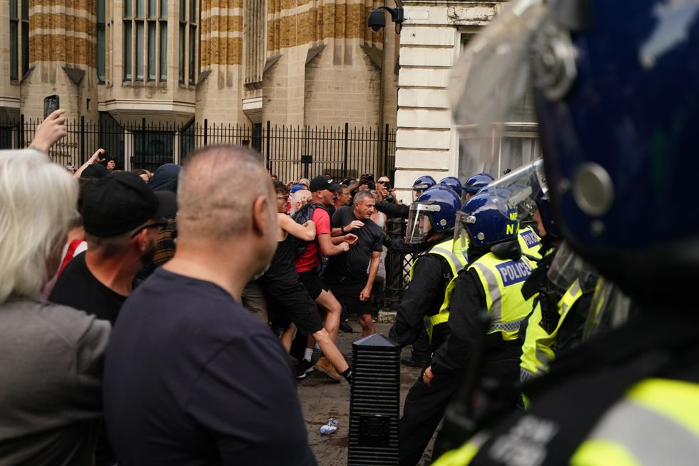 Police officers scuffle with people attending the 'Enough is Enough' protest in Whitehall