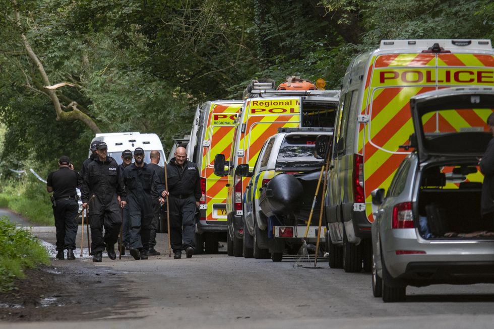 Police officers searching the land at Sand Hutton Gravel Pits near York in connection with the disappearance of missing university chef Claudia Lawrence.