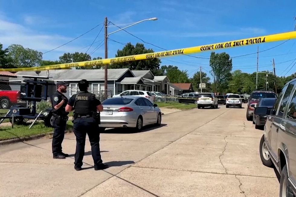 Police officers secure a street where eight children were killed in a mass shooting in Shreveport, Louisiana