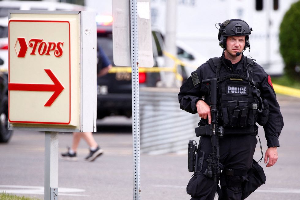 Police officers secure the scene after a shooting at TOPS supermarket in Buffalo, New York.