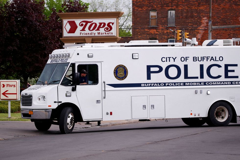 Police officers secure the scene after a shooting at TOPS supermarket in Buffalo, New York.