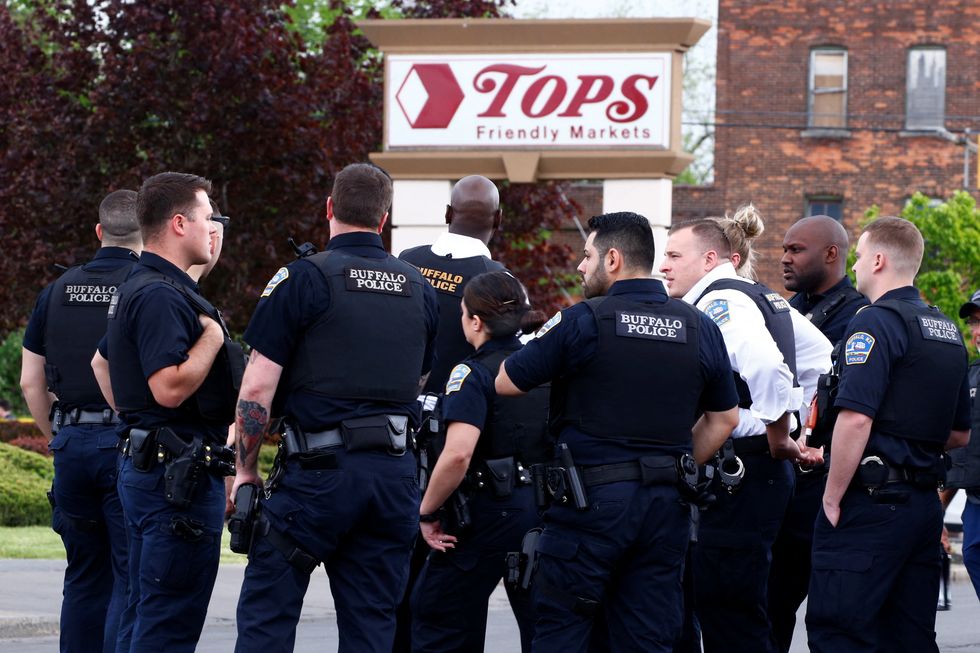 Police officers secure the scene after a shooting at TOPS supermarket in Buffalo.