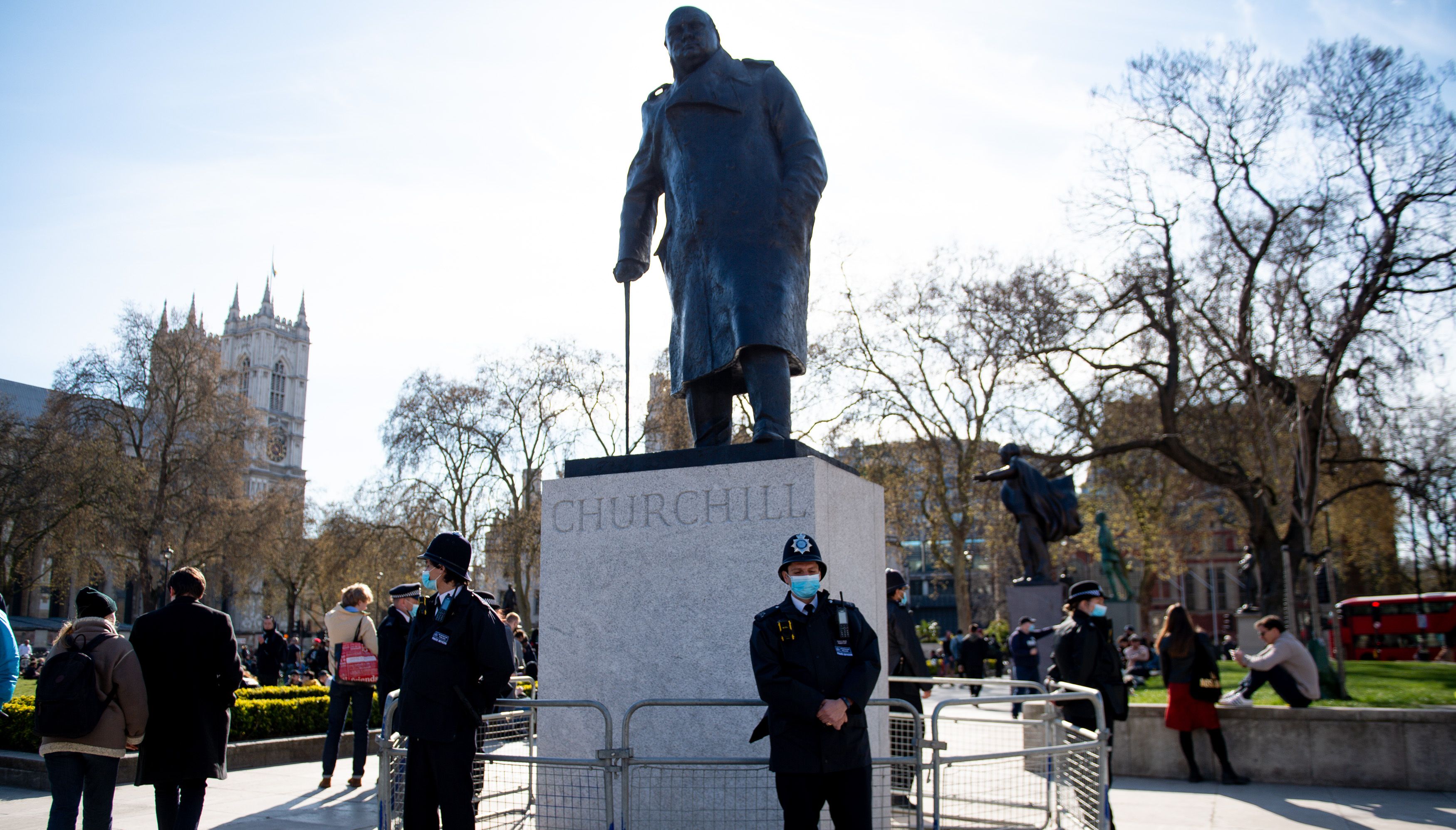 Police officers stand by a statue of Winston Churchill during a 'Kill The Bill' protest against The Police, Crime, Sentencing and Courts Bill in Parliament Square, London. Picture date: Saturday April 17, 2021.