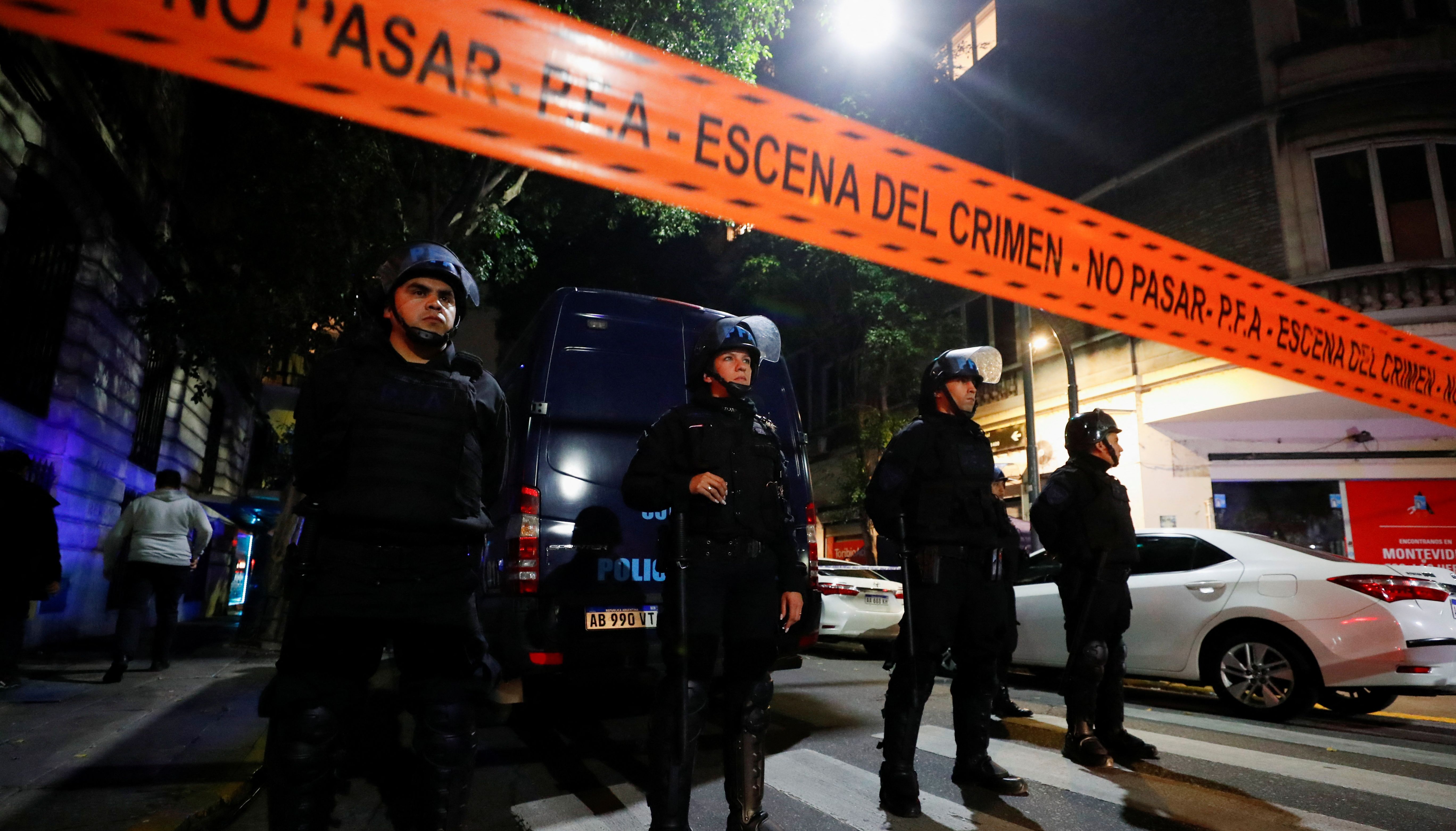 Police officers stand guard outside the house of Argentina's Vice-President Cristina Fernandez de Kirchner after she was attacked by an unidentified assailant with a gun late on Thursday.