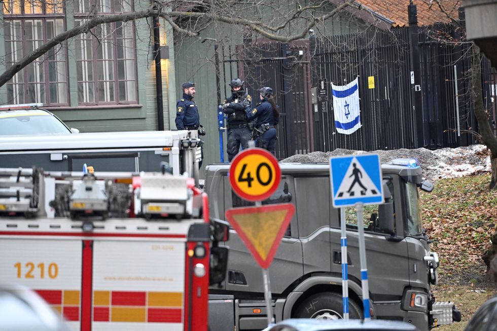 Police officers stand near the Israeli embassy