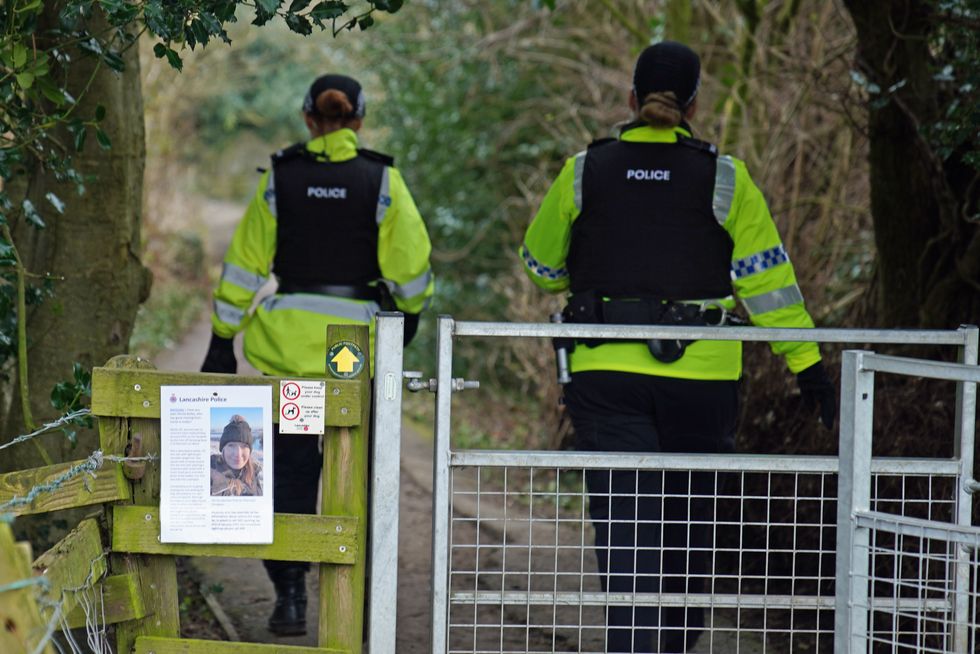 Police officers walk along a footpath in St Michael's on Wyre, Lancashire, as they continue their search for missing woman Nicola Bulley, 45, who was last seen on the morning of Friday January 27, when she was spotted walking her dog on a footpath by the nearby River Wyre. Picture date: Sunday February 12, 2023.