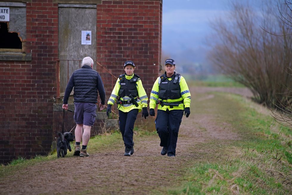 Police officers walk along a footpath in St Michael's on Wyre, Lancashire, as they continue their search for missing woman Nicola Bulley, 45, who was last seen on the morning of Friday January 27, when she was spotted walking her dog on a footpath by the nearby River Wyre. Picture date: Sunday February 12, 2023.