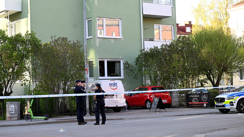 Police officers work near the scene where several people were injured after a series of loud bangs that indicated gunfire