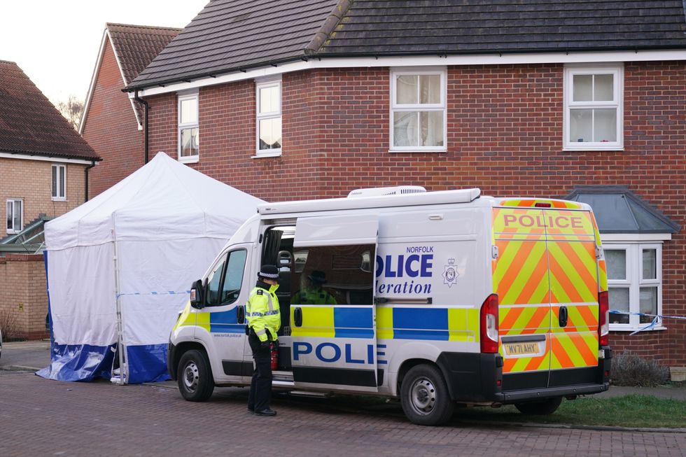 Police outside a house in Costessey near Norwich after four people were found dead