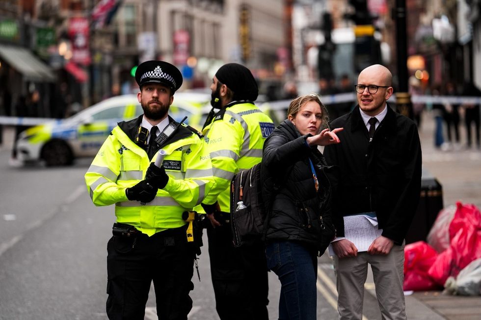 Police outside the cordon at \u200bShaftesbury Avenue