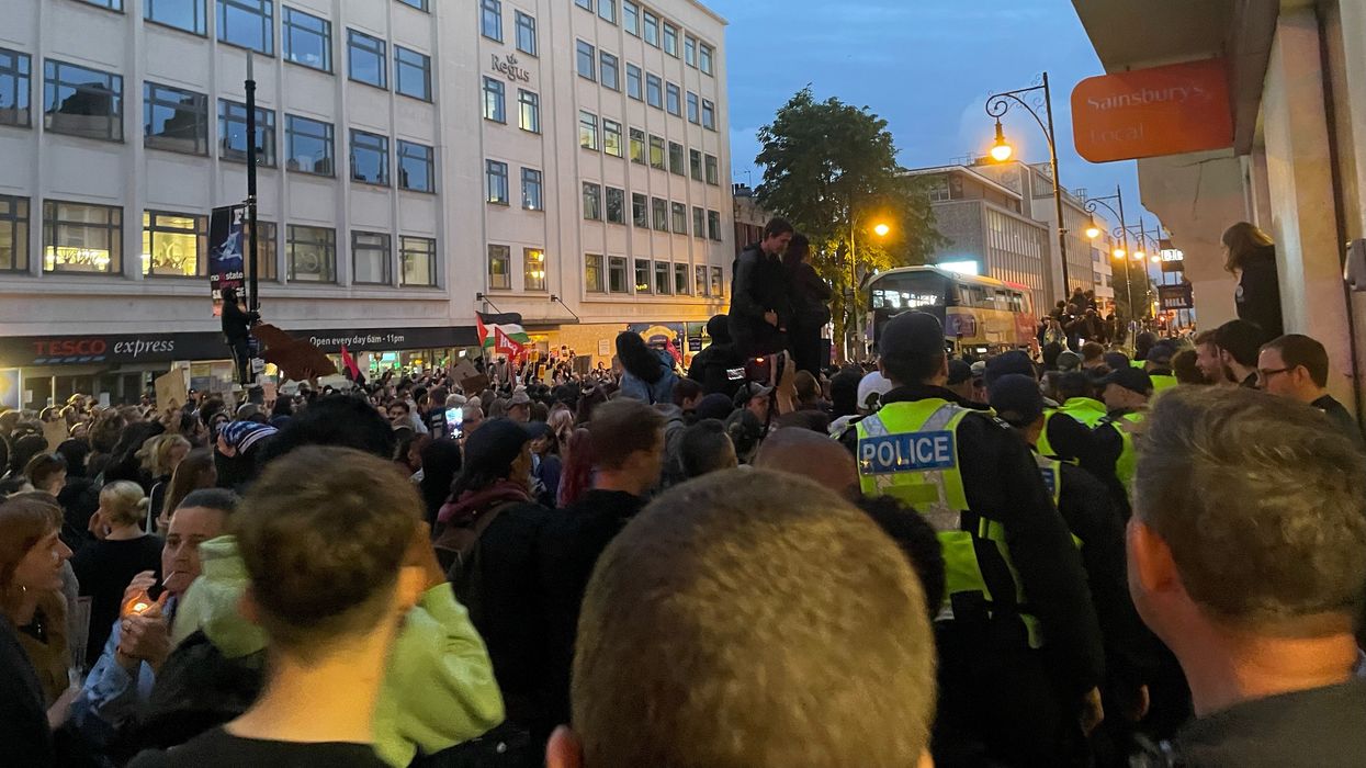 Police protect four demonstrators as counter-protesters surround quartet