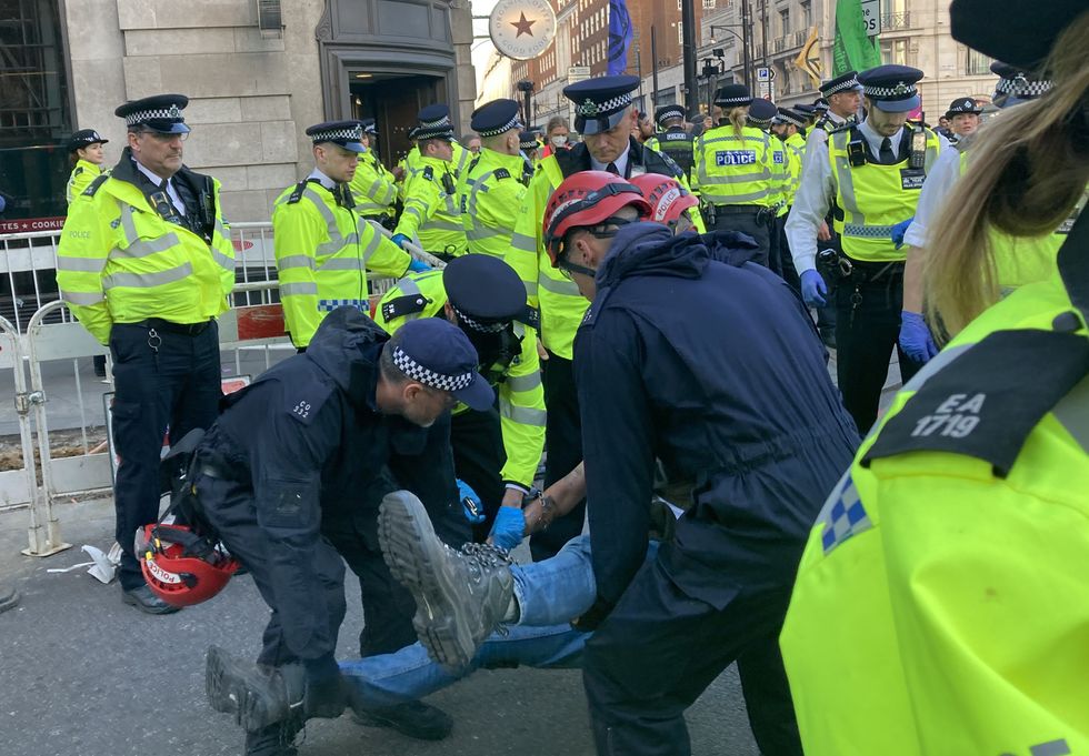 Police remove demonstrators during an Extinction Rebellion protest at Marble Arch in central London.