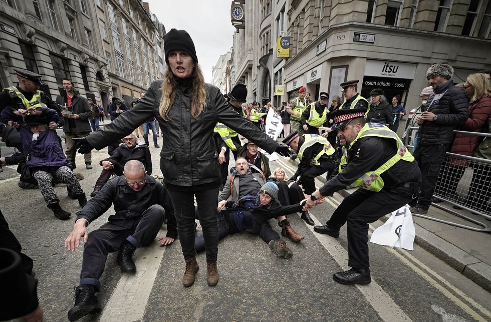 Police remove Extinction Rebellion protestors during the Lord Mayor's Show parade in the City of London. Picture date: Saturday November 13, 2021.