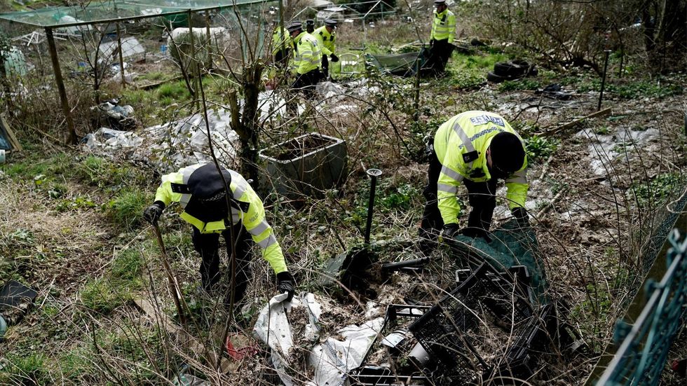 Police search teams in Roedale Valley Allotments, Brighton look through allotments