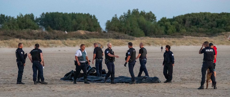 Police smiled and shook hands with each other after destroying the dinghy