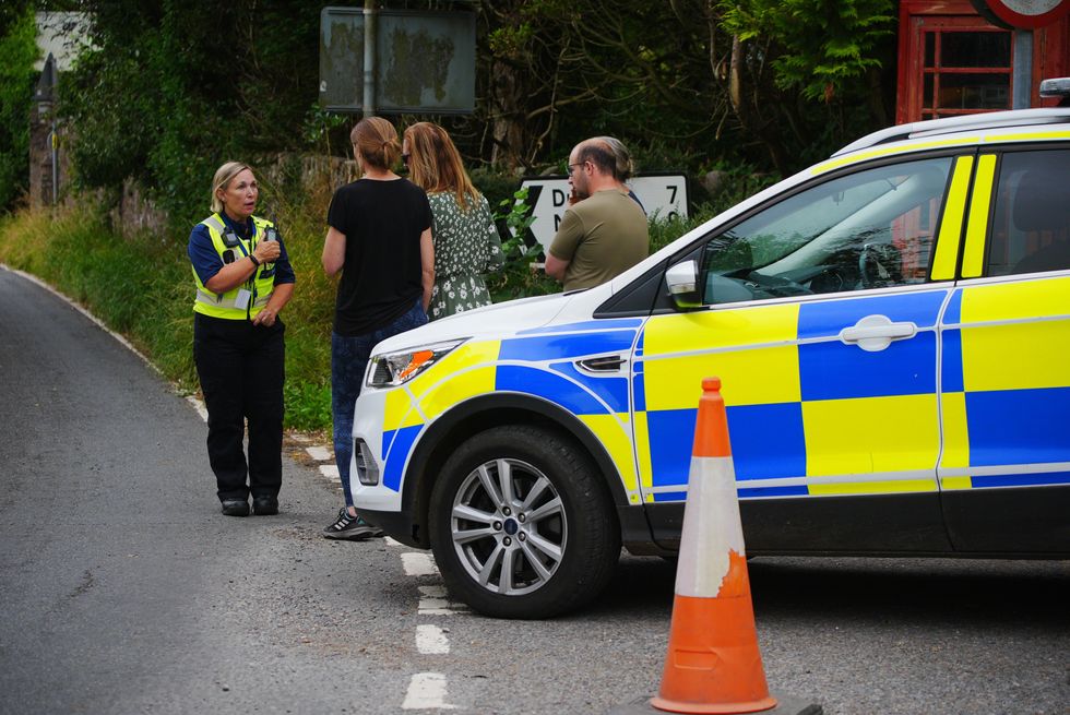 Police speak to locals on Thursday afternoon after the school bus crash