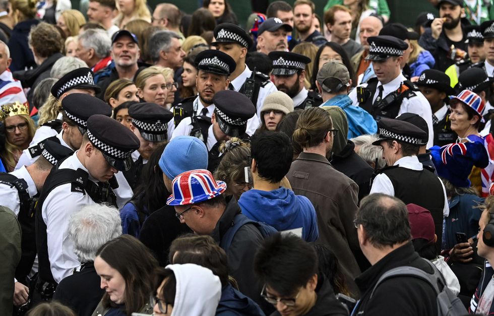 Police speak with Just Stop Oil protesters in central London, following the coronation ceremony of King Charles III and Queen Camilla