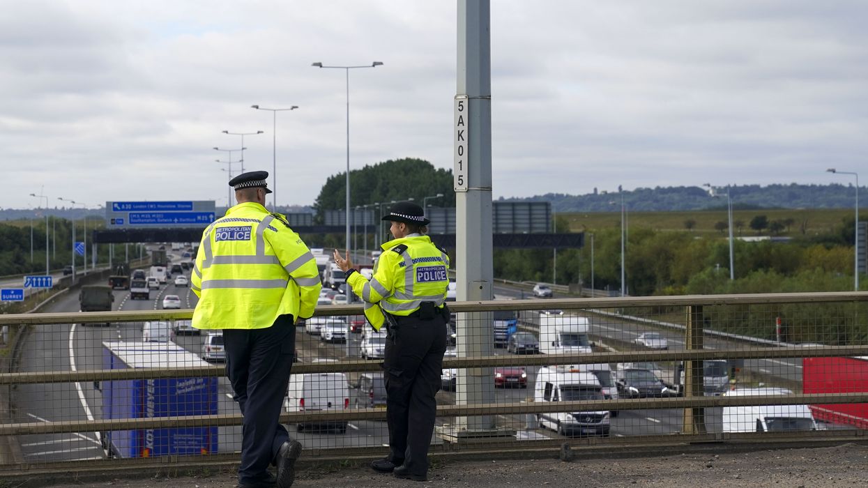 Police standing over a UK motorway