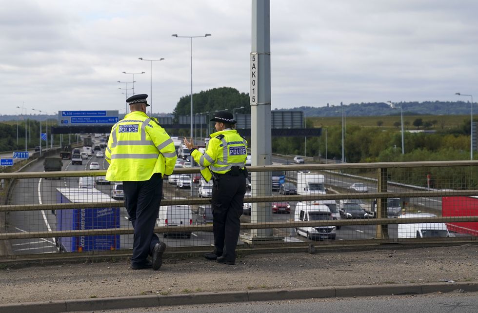 Police standing over a UK motorway