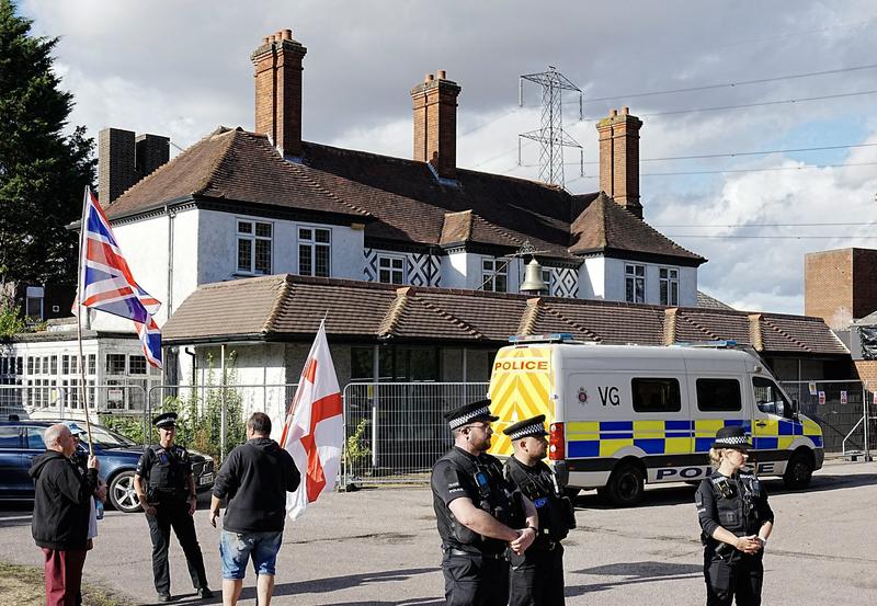Police stood outside the Bell Hotel in Epping