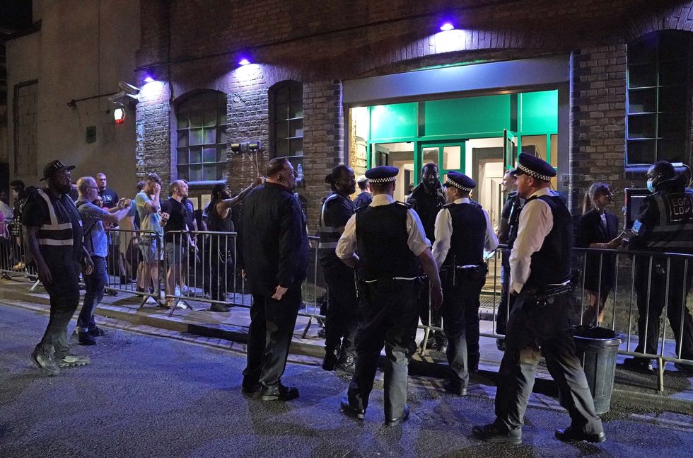 Police talk to security as people queue up for the Egg nightclub in London, after the final legal coronavirus restrictions were lifted in England at midnight. Picture date: Monday July 19, 2021.