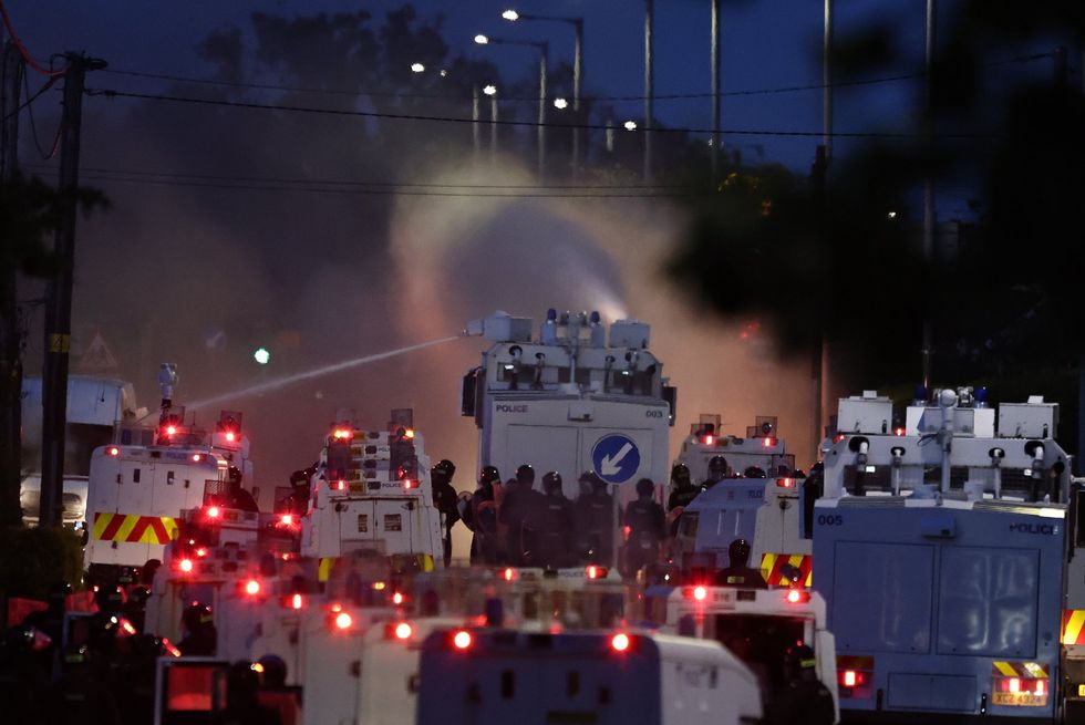 Police vans using water cannons