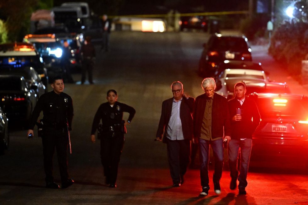 Police walk towards Matthew Perry's home