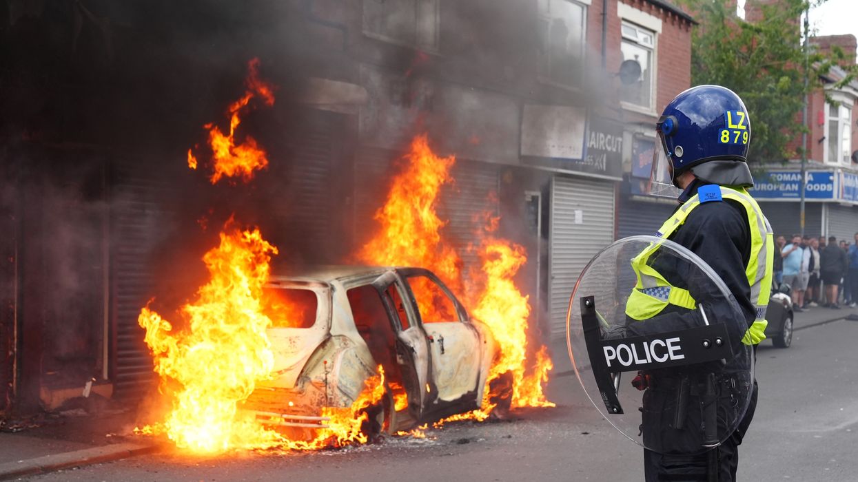 Police wathces a car burn in Middlesborough