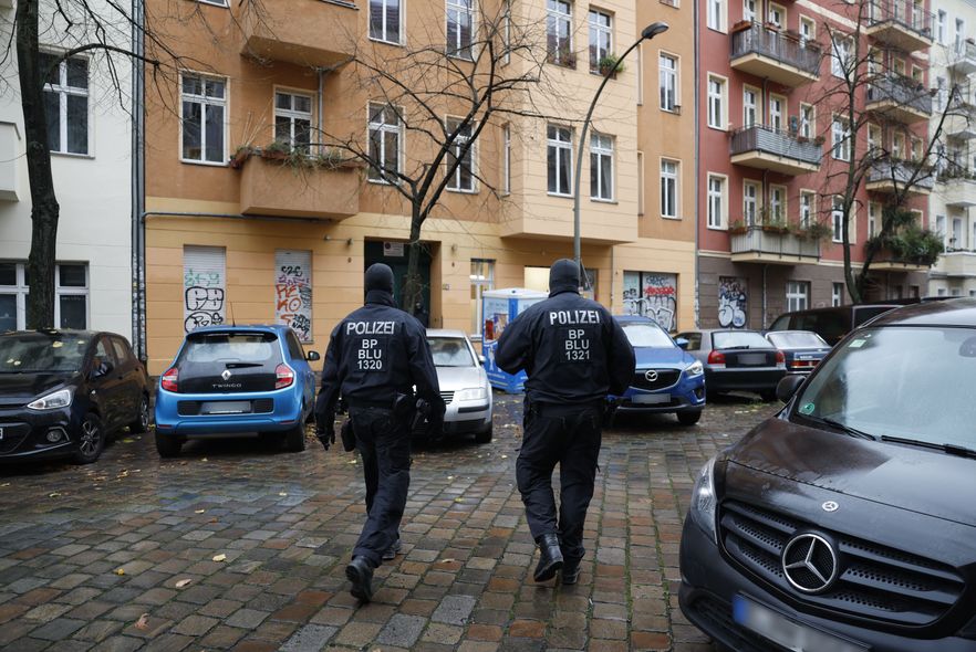 Policemen are seen in front of a house in Berlin's Friedrichshain district, as a raid was under way against Hamas