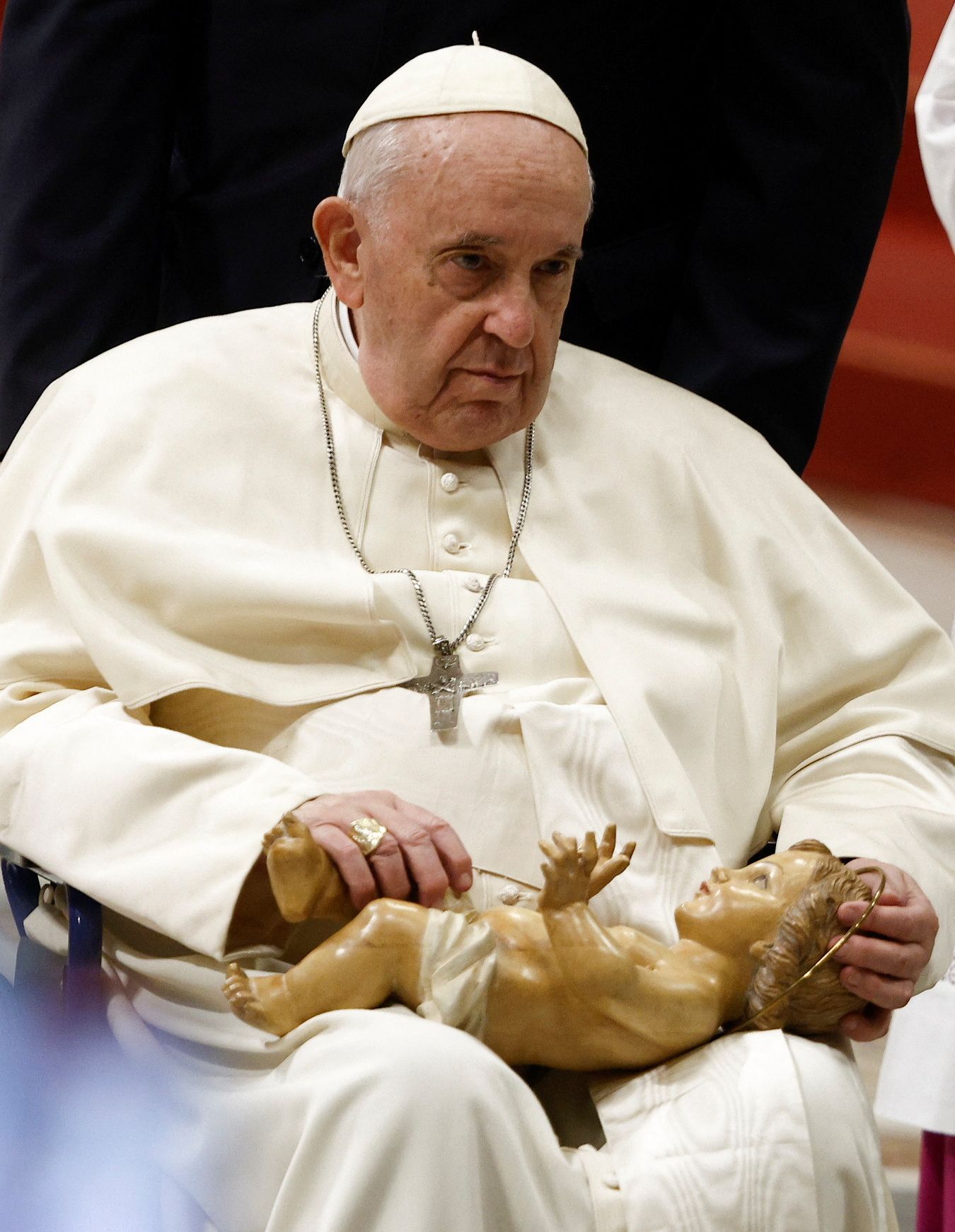 Pope Francis holds a statue of Baby Jesus during the Christmas Eve mass in St. Peter's Basilica at the Vatican, December 24, 2022. REUTERS/Guglielmo Mangiapane