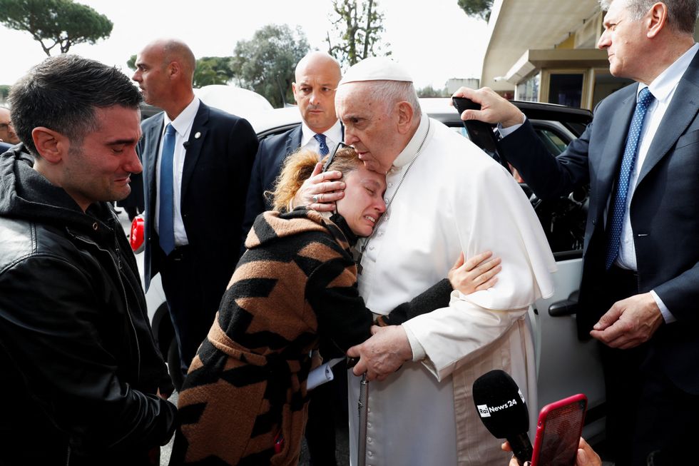 Pope Francis hugging a woman