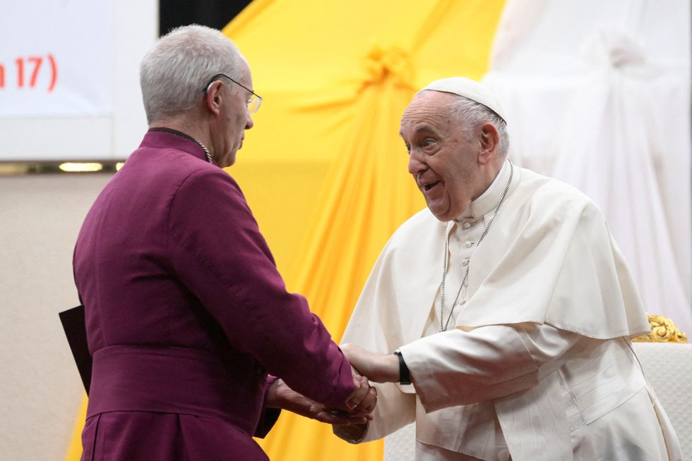 Pope Francis shakes hands with Archbishop of Canterbury Justin Welby as he leads an ecumenical prayer at the John Garang Mausoleum during his apostolic journey, in Juba, South Sudan, February 4, 2023. Vatican Media/Handout via REUTERS ATTENTION EDITORS - THIS IMAGE WAS PROVIDED BY A THIRD PARTY