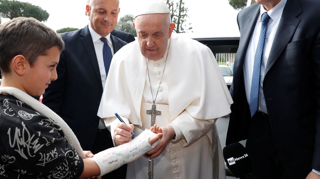 Pope Francis signing a boy's cast