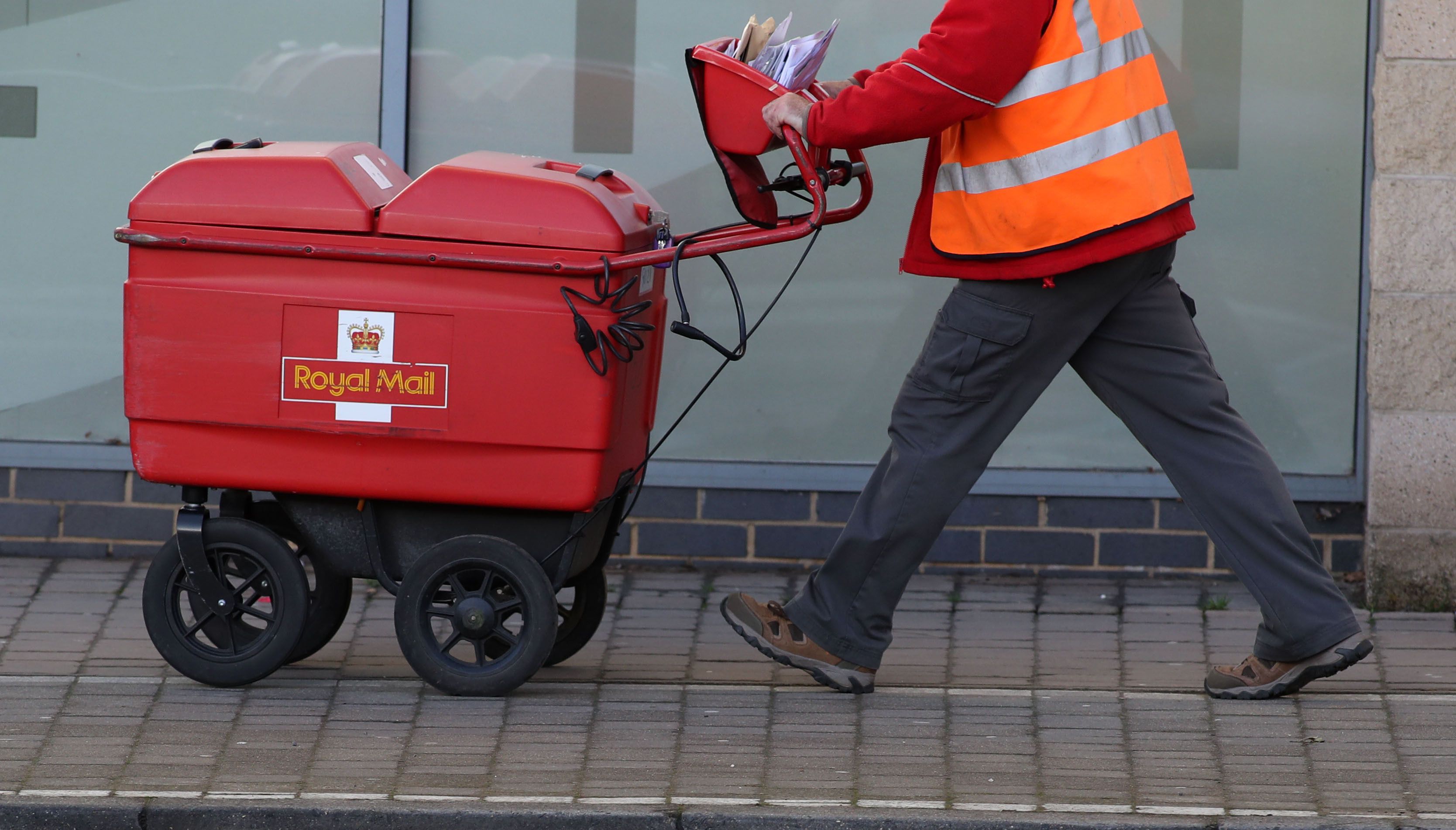 Postman delivering letters in Woking, Surrey.