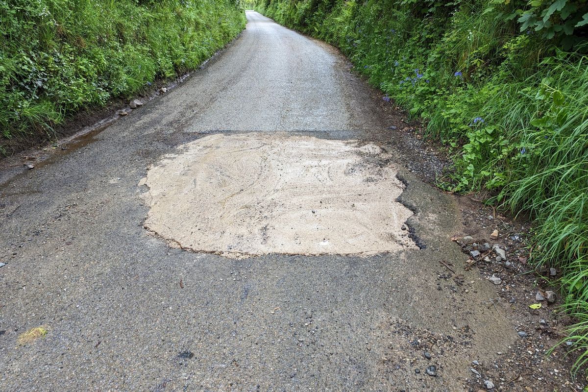 Pothole filled with concrete on road in Cornwall