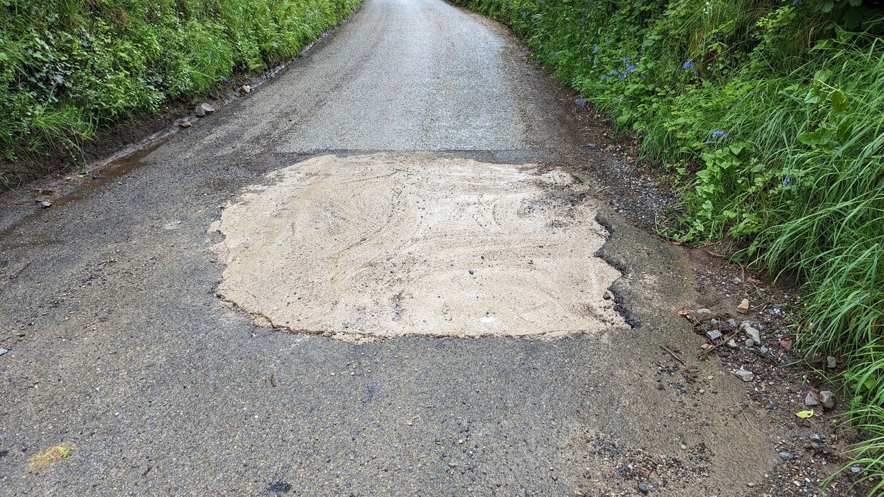 Pothole filled with concrete on road in Cornwall