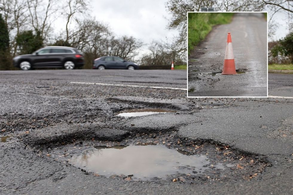 Pothole on road and a traffic cone