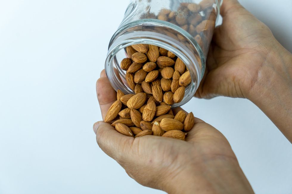 Pouring from a jar of almonds