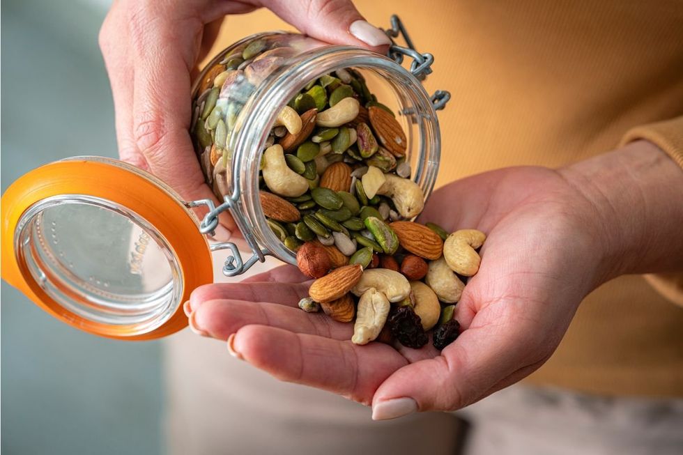 POURING NUTS INTO HAND