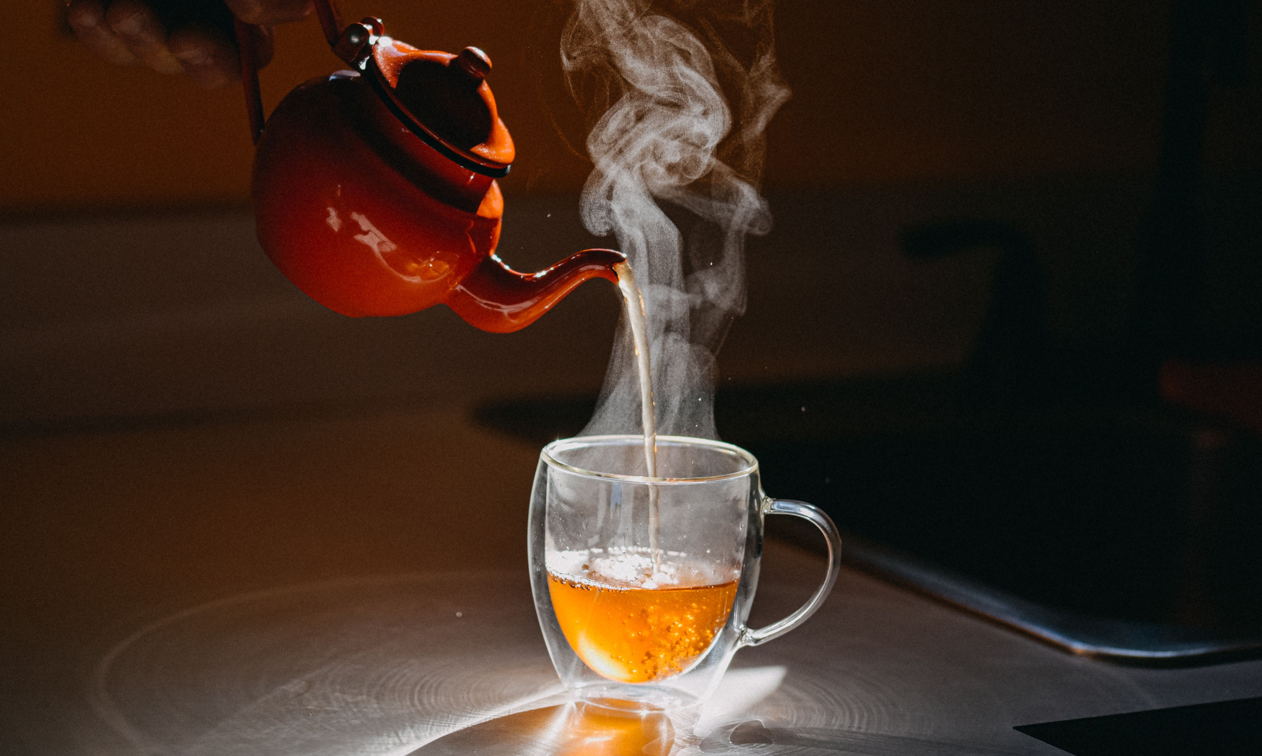 POURING TEA INTO CUP