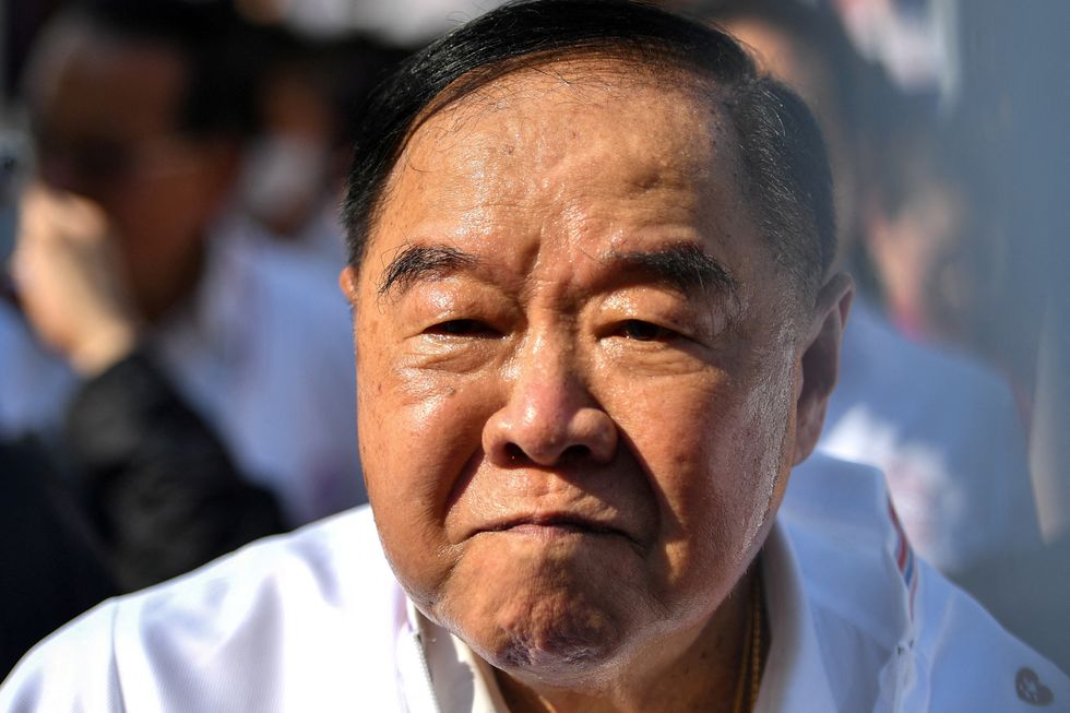 Prawit Wongsuwon, 79, struck the woman several times after being surrounded by journalists