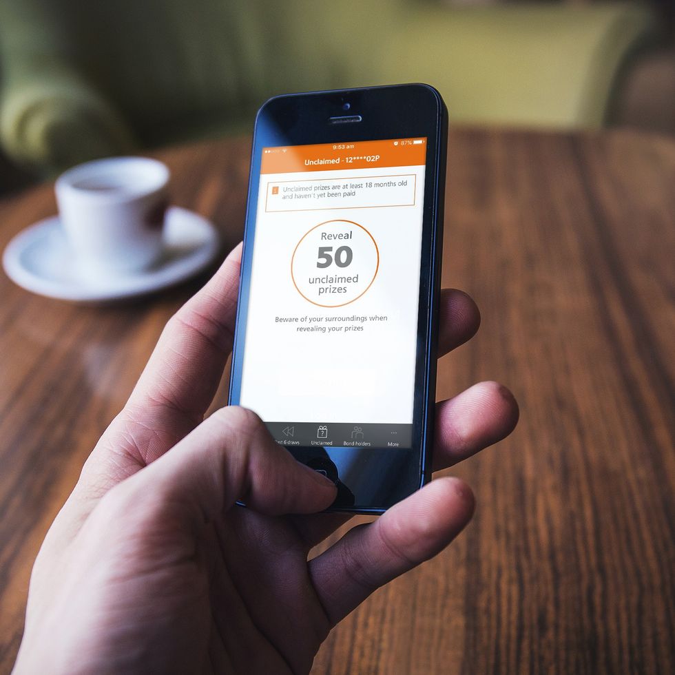 Premium Bonds saver uses NS&I prize checker app on their phone