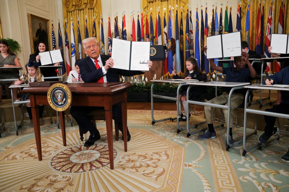 President Donald Trump shows his signature on an executive order to shut down the Department of Education\u200b