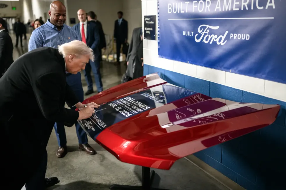 President Donald Trump signing a Ford during his visit to its Michigan factory