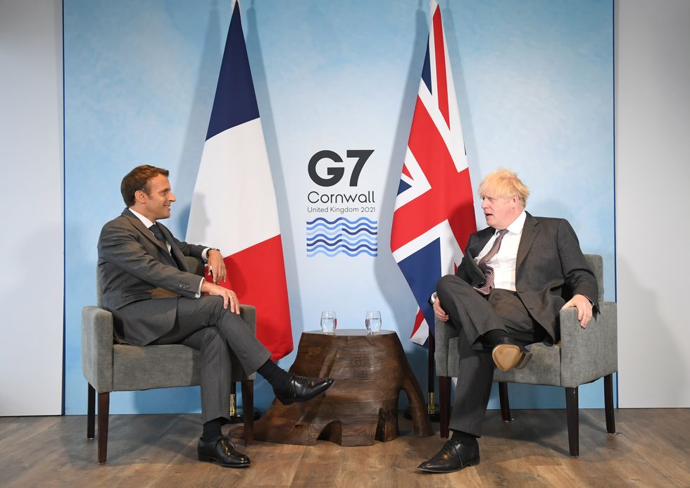 President Emmanuel Macron talks to Boris Johnson ahead of a bilateral meeting during the G7 summit in Cornwall.